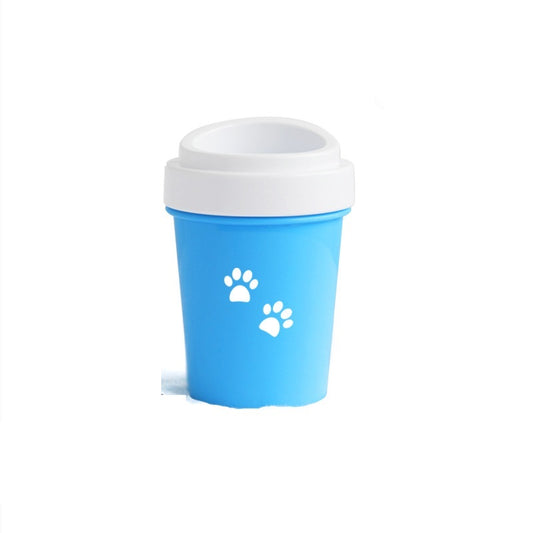 Cleaning a dog's muddy paw in a silicone paw washer cup