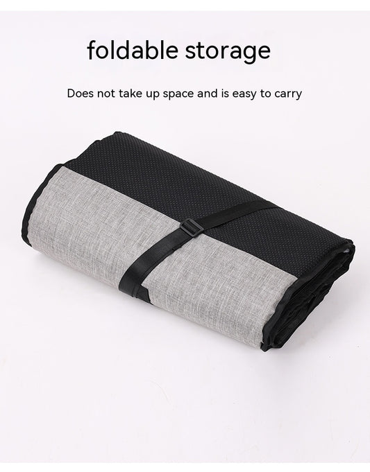 Dog curled up in a soft portable car travel nest