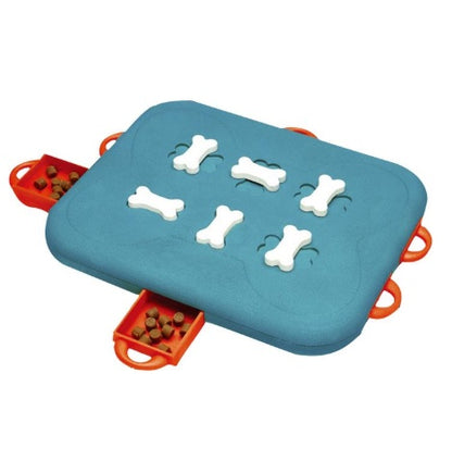 Dog nosing a treat-dispensing puzzle toy to release hidden snacks