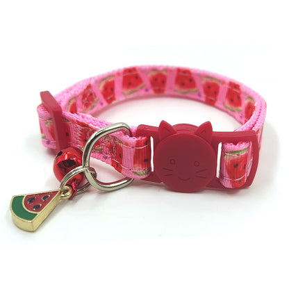 Cat wearing an adjustable fruit-print collar with a bell