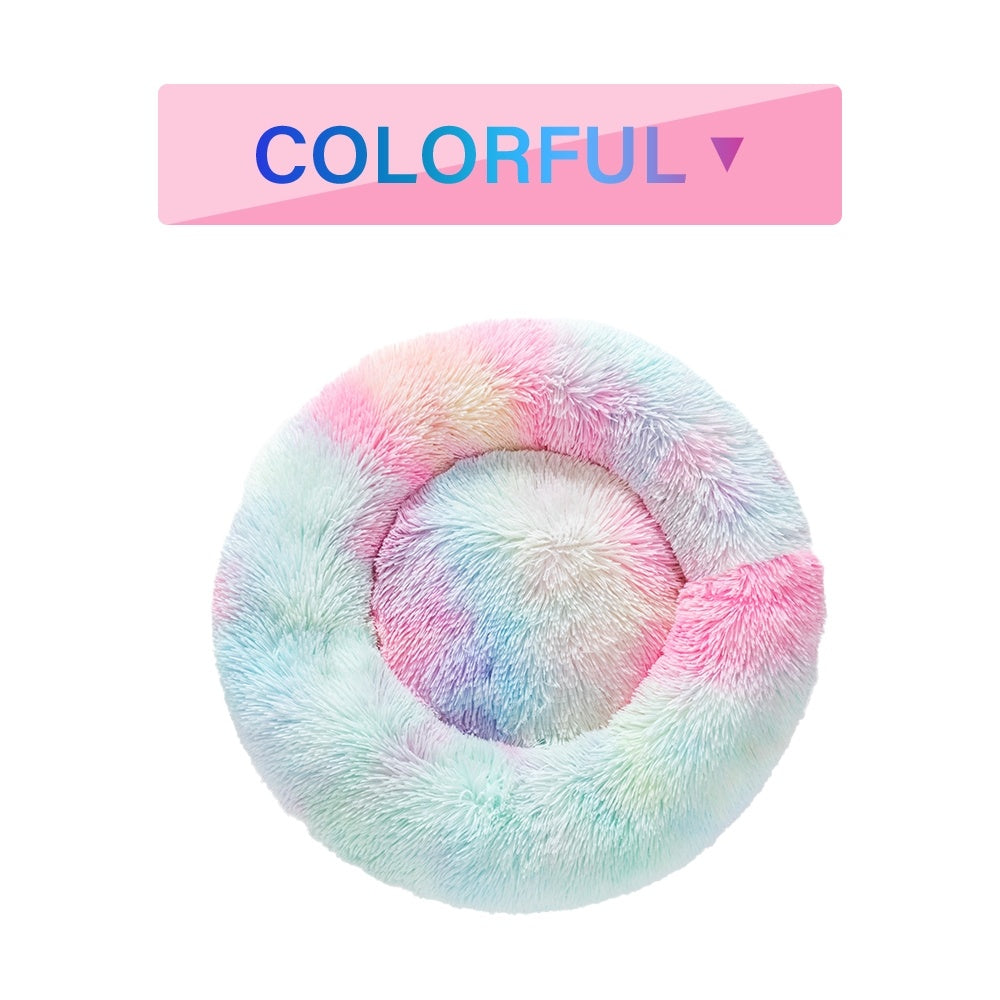 Dog curled up asleep in a calming donut bed with raised rim