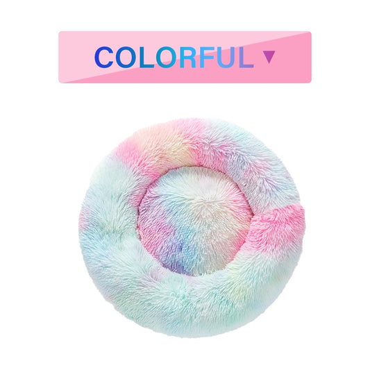 Dog curled up asleep in a calming donut bed with raised rim