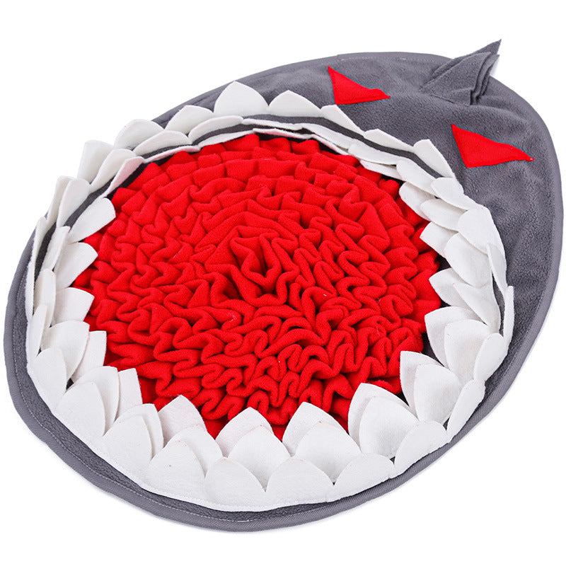 Dog sniffing for hidden treats in a plush snuffle mat